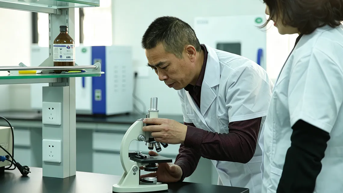 OEM cosmetic intimate care factory R&D laboratory, researchers testing product sample in modern lab